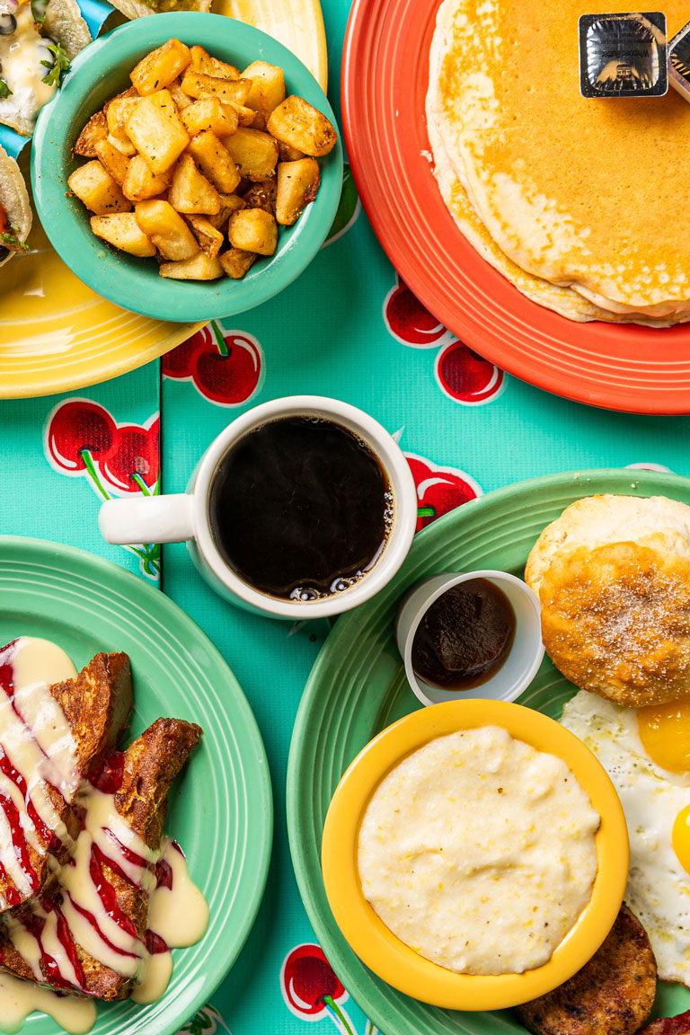 Overhead Shot of French Toast, Grits, Coffee, Buttermilk Pancakes and Biscuits